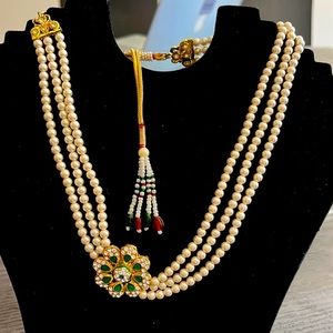 New three strand pearl necklace with a floral inspired theme.  Fair offers.